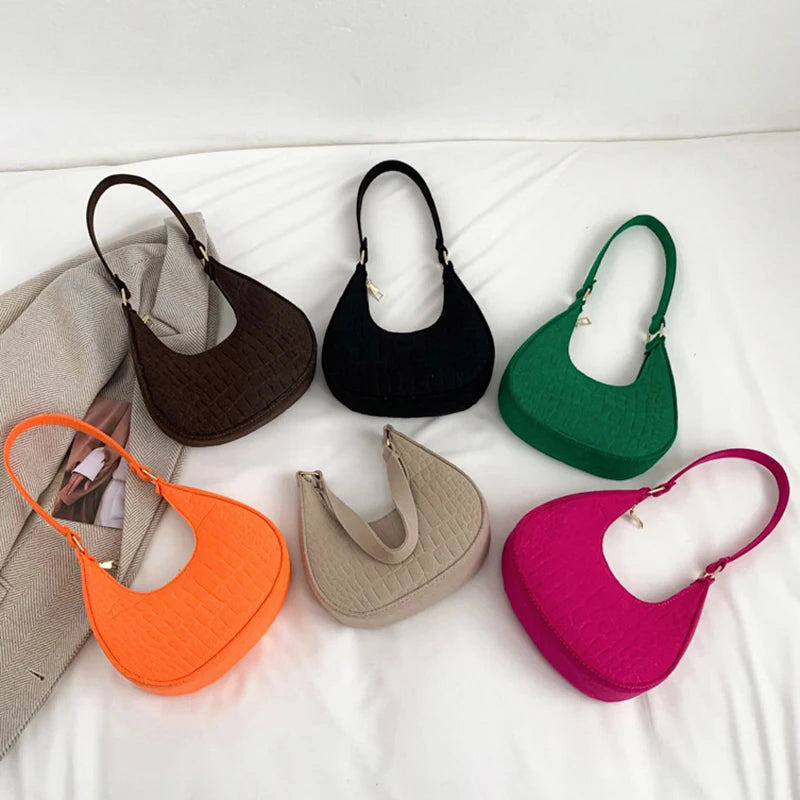 Sac tendance en feutre de haute qualité, au style rétro et élégant. Conçu pour être porté sous le bras ou à l’épaule, il allie simplicité et design moderne.