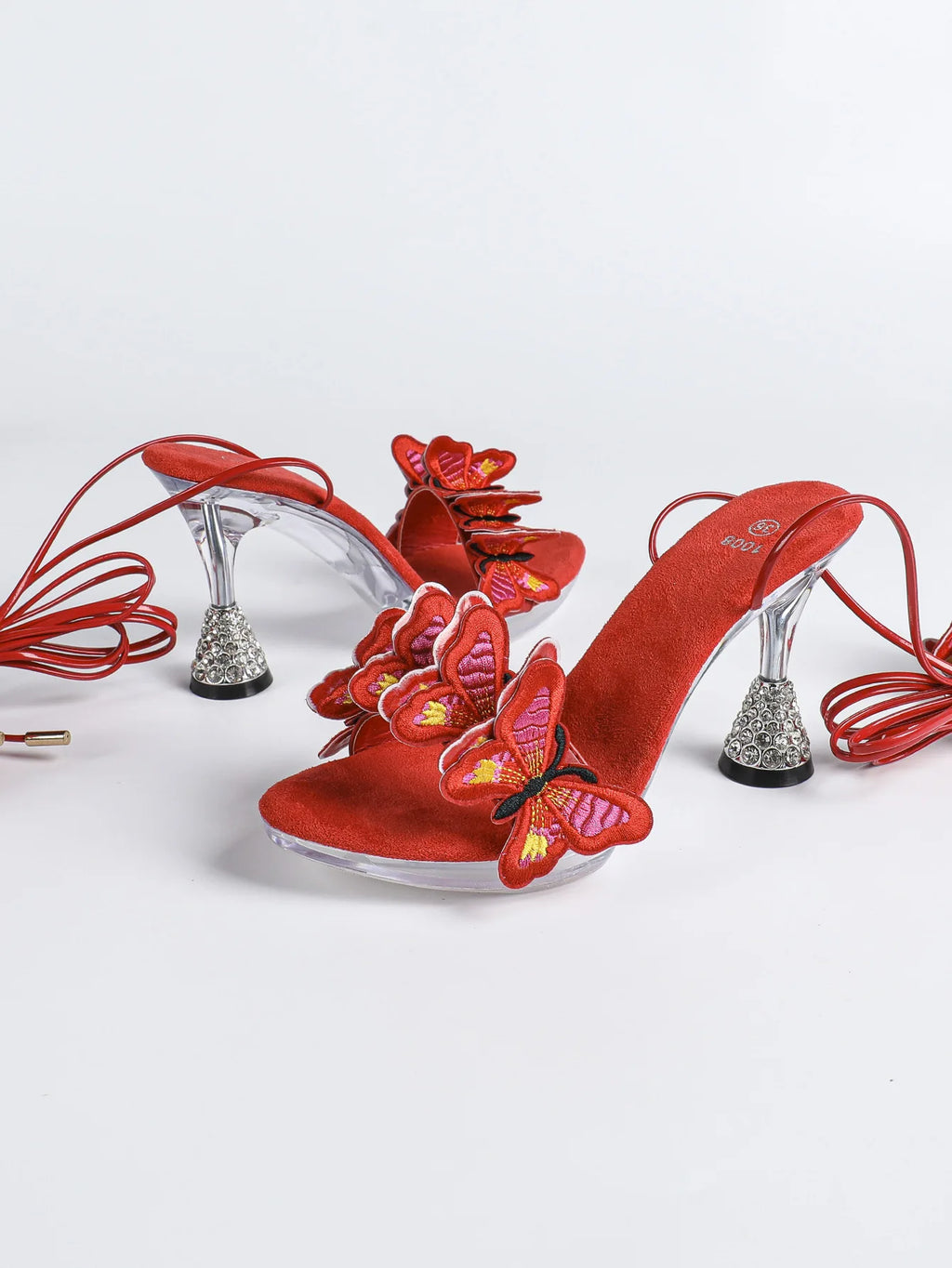 Sandales rouges tendance pour femme été 2026, fabriquées à la main avec broderie papillon. Modèle à brides croisées, bout rond et talons hauts fins de 8 cm. Des chaussures sexy et élégantes, idéales pour la danse, les soirées et les occasions spéciales.